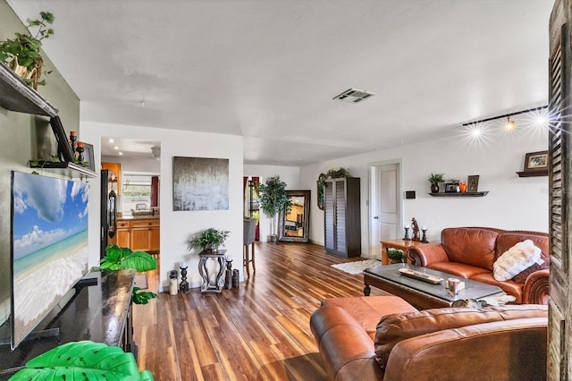 living room with wood finished floors and visible vents