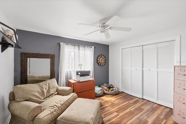 living area featuring ceiling fan and wood finished floors