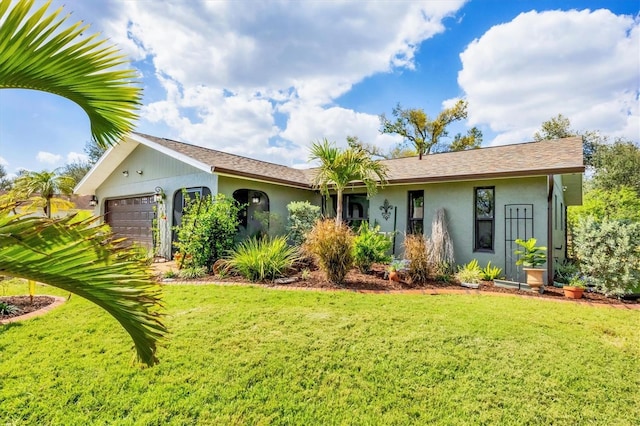 single story home with a front lawn, an attached garage, and stucco siding