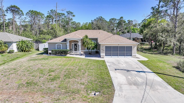 ranch-style house with fence, concrete driveway, a front yard, stucco siding, and a garage