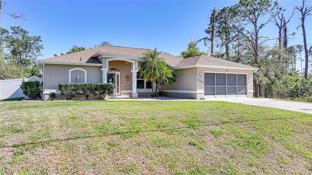 single story home featuring a front yard, fence, driveway, and stucco siding