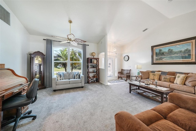 carpeted living area with a ceiling fan, visible vents, and high vaulted ceiling