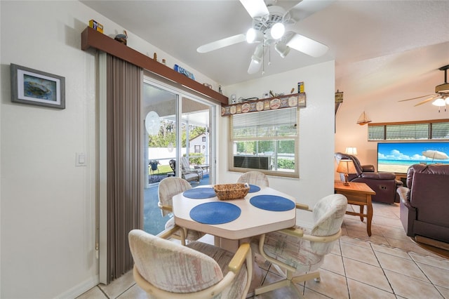 dining space with light tile patterned floors, baseboards, and a ceiling fan