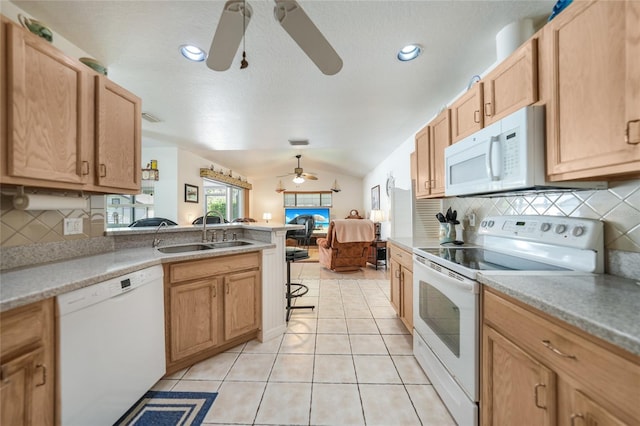 kitchen with white appliances, a ceiling fan, lofted ceiling, a sink, and open floor plan