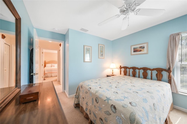 bedroom with a ceiling fan, light colored carpet, visible vents, and baseboards