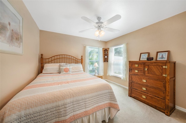 bedroom with baseboards, light colored carpet, and ceiling fan