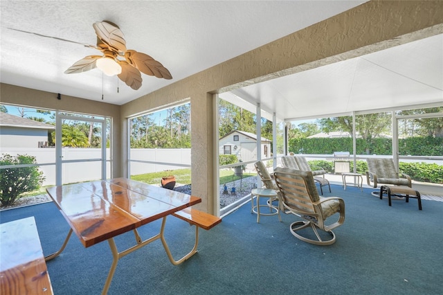 sunroom / solarium featuring ceiling fan