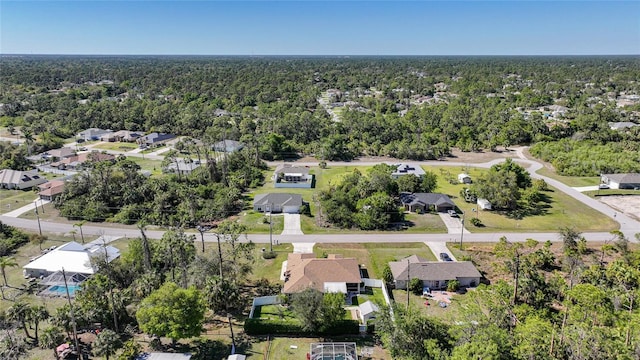 birds eye view of property featuring a residential view and a wooded view