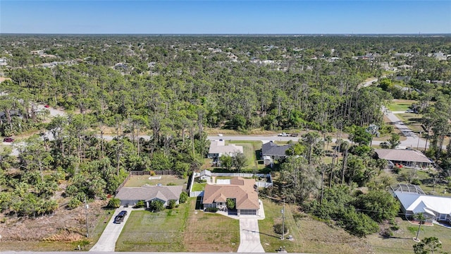 birds eye view of property with a residential view and a wooded view