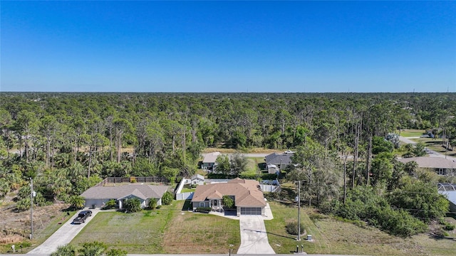 drone / aerial view with a wooded view