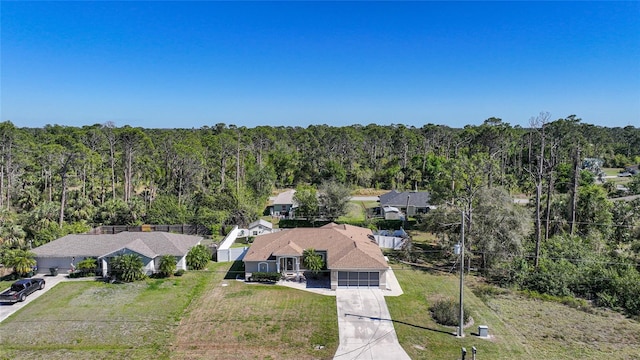 drone / aerial view with a wooded view