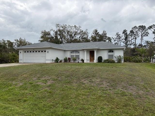 single story home featuring a front yard, driveway, an attached garage, and stucco siding