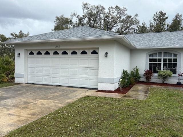 view of home's exterior with a garage, stucco siding, concrete driveway, and roof with shingles