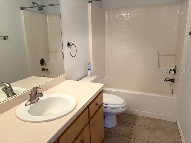 full bath featuring  shower combination, vanity, toilet, and tile patterned floors