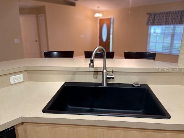 kitchen featuring light countertops and a sink