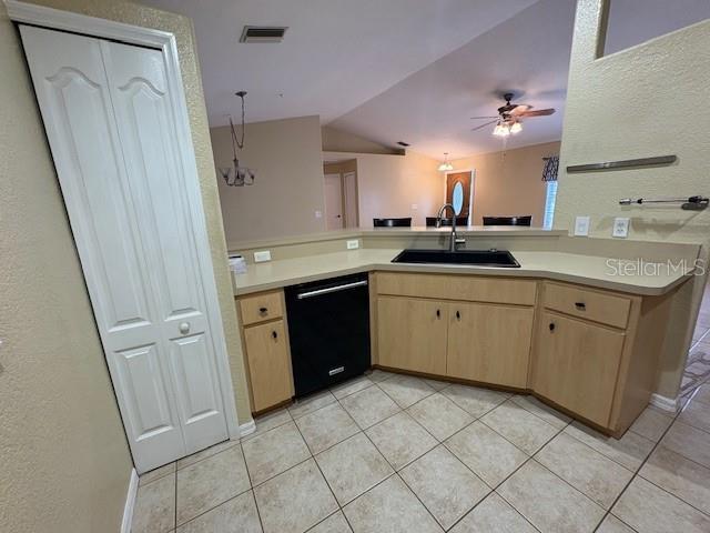 kitchen featuring light countertops, visible vents, light brown cabinets, a sink, and dishwasher