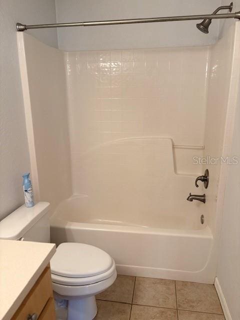 full bath featuring toilet, shower / bath combination, vanity, and tile patterned floors