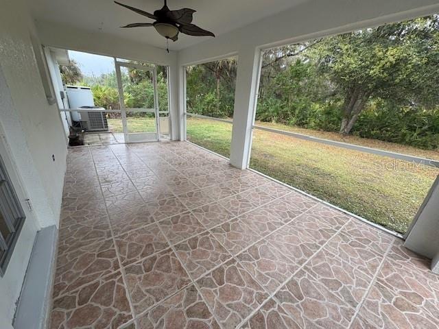 unfurnished sunroom with ceiling fan