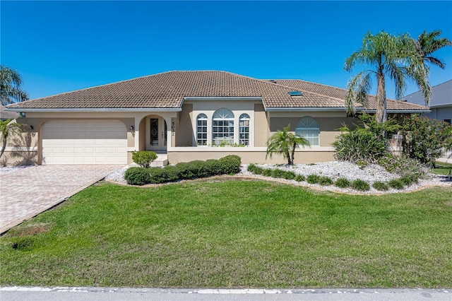 view of front of house featuring a garage, a tile roof, and stucco siding