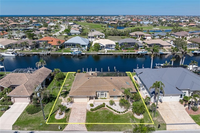 birds eye view of property with a water view and a residential view