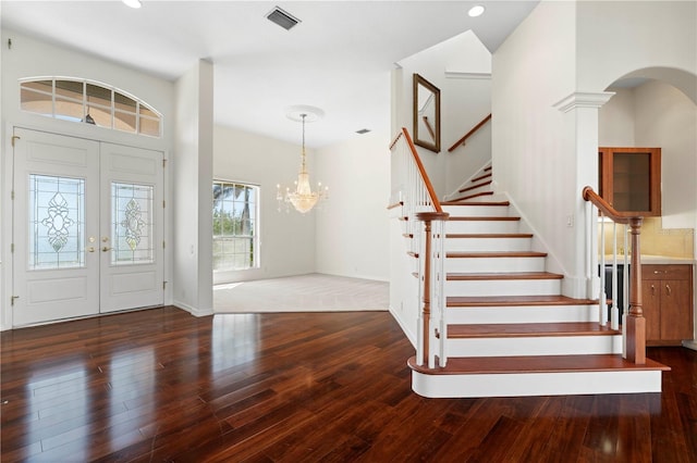 entrance foyer featuring recessed lighting, wood-type flooring, visible vents, an inviting chandelier, and stairs