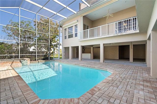 view of pool featuring a pool with connected hot tub, a lanai, a patio, and ceiling fan