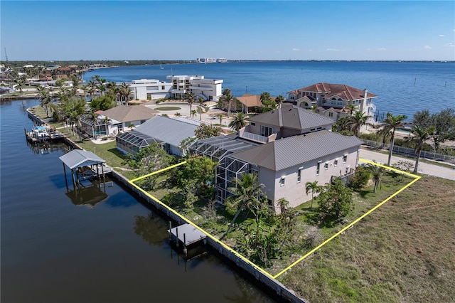 birds eye view of property featuring a water view and a residential view