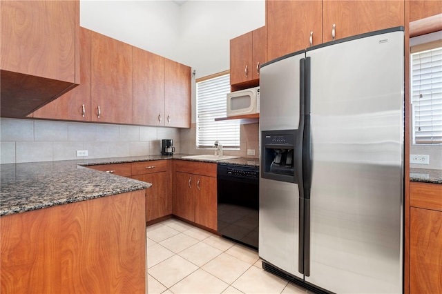 kitchen with decorative backsplash, white microwave, light tile patterned flooring, dishwasher, and stainless steel fridge with ice dispenser