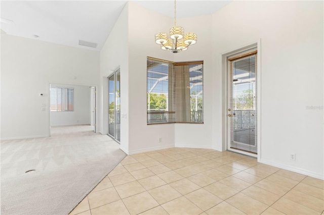 interior space featuring a chandelier, light tile patterned flooring, light carpet, a high ceiling, and visible vents