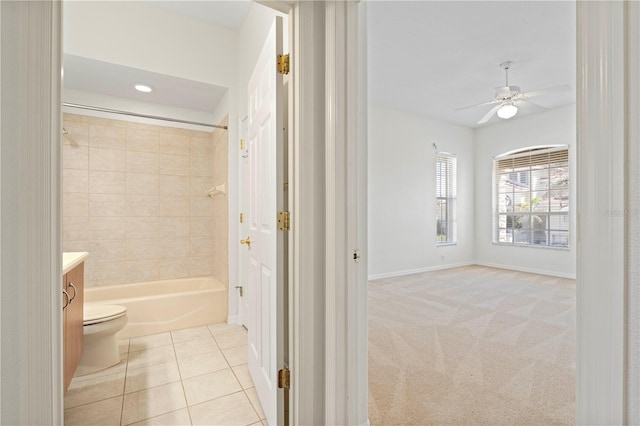 bathroom featuring baseboards, ceiling fan, tile patterned flooring, vanity, and shower / washtub combination