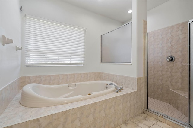 bathroom featuring a shower stall, a whirlpool tub, and tile patterned floors