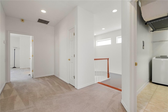 corridor featuring washer / dryer, visible vents, carpet flooring, and an upstairs landing