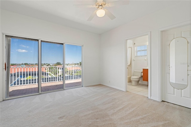 empty room featuring carpet floors, baseboards, and a ceiling fan