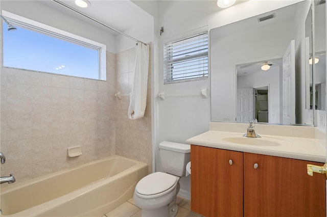 full bathroom with tile patterned flooring, toilet, visible vents, vanity, and shower / bathtub combination with curtain