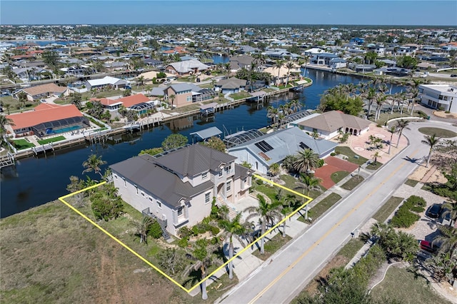 drone / aerial view featuring a residential view and a water view