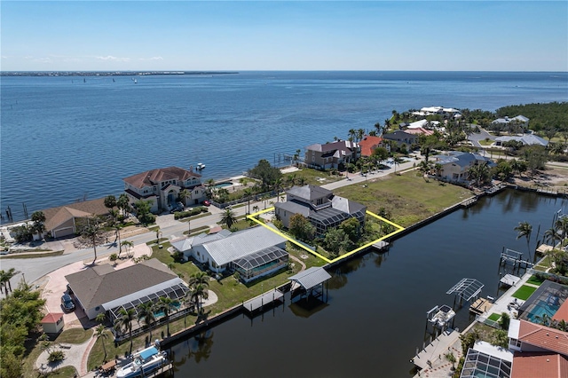 birds eye view of property with a water view and a residential view