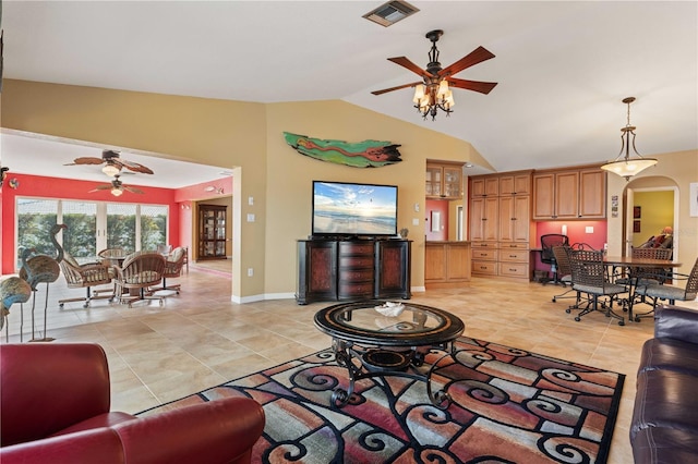 living room with arched walkways, lofted ceiling, visible vents, baseboards, and a ceiling fan