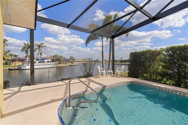 outdoor pool featuring a patio area, a water view, and a lanai
