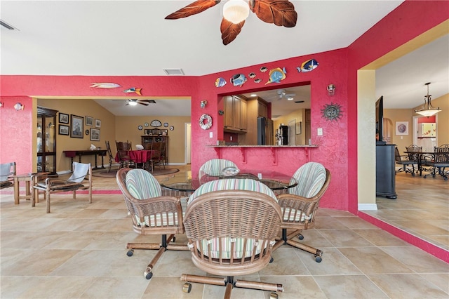 tiled dining area featuring a ceiling fan and visible vents