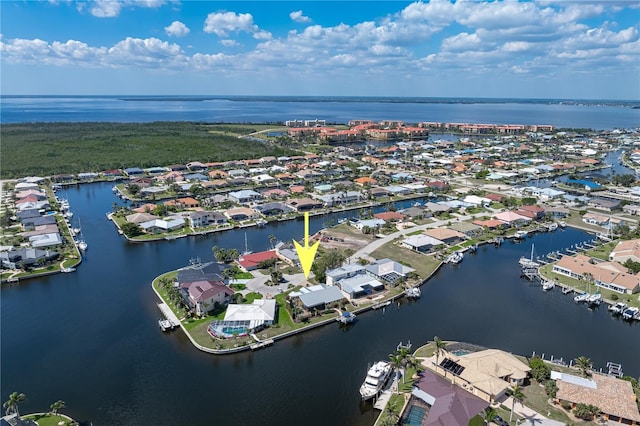 drone / aerial view with a water view and a residential view
