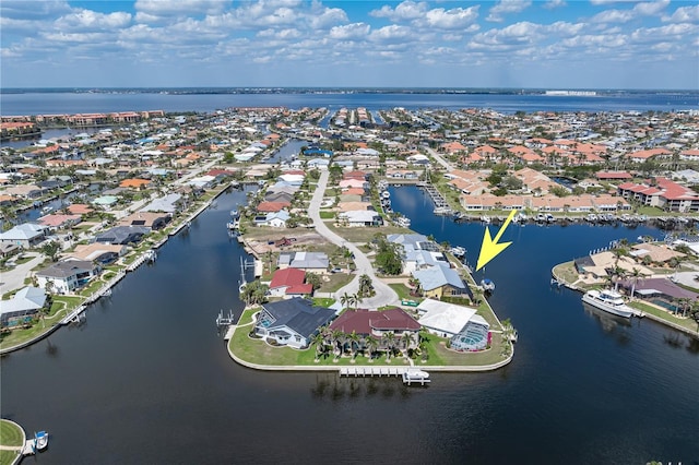 birds eye view of property with a water view and a residential view