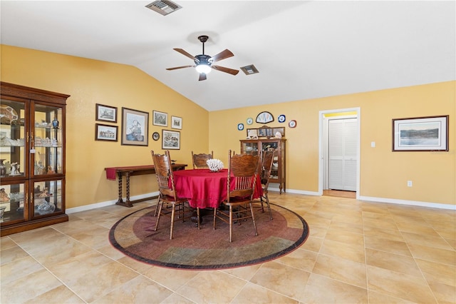 dining room with light tile patterned floors, baseboards, visible vents, a ceiling fan, and lofted ceiling