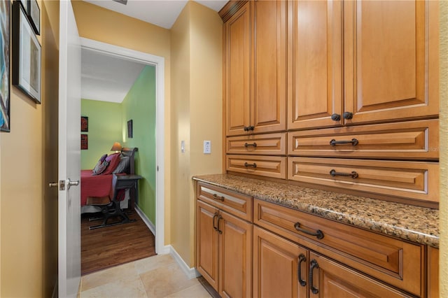 hall with light tile patterned floors and baseboards