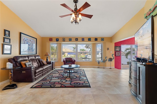 living area with lofted ceiling, light tile patterned floors, baseboards, and a ceiling fan