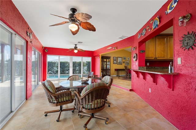 dining space with a ceiling fan, visible vents, and light tile patterned floors