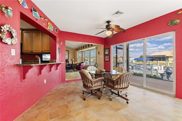 dining space with light tile patterned floors, ceiling fan, and visible vents