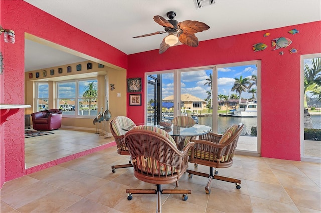 dining area featuring light tile patterned floors, ceiling fan, visible vents, and baseboards