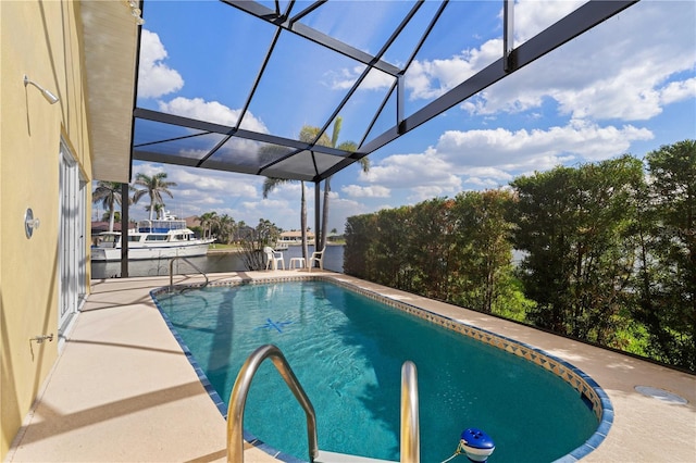 outdoor pool featuring glass enclosure, a patio, and a water view