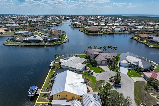 drone / aerial view with a water view and a residential view