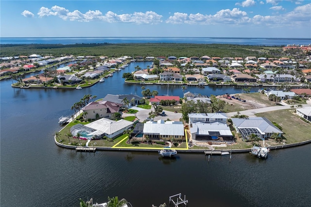 birds eye view of property with a water view and a residential view